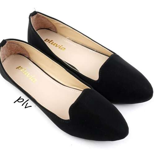 a pair of black flat shoes with a gold logo on the sole.