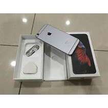 an apple computer in a box on a floor.