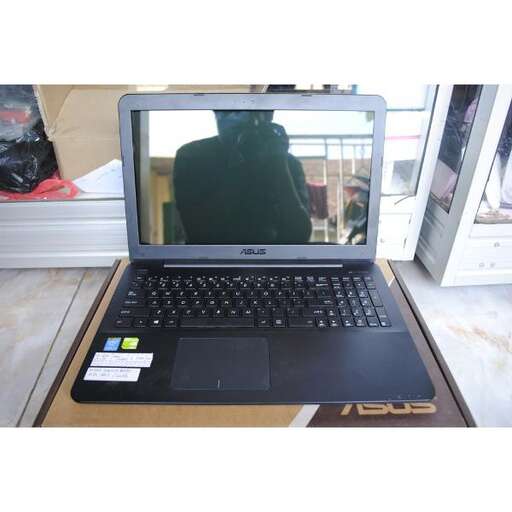 a laptop computer sitting on top of a wooden table.
