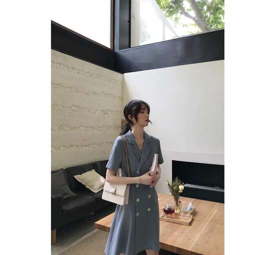 a woman in a dress standing in a room.