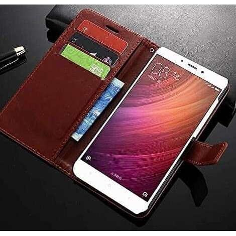 a cell phone is sitting on a table next to a cell phone.