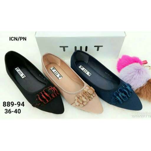 a pair of flat shoes with a bow