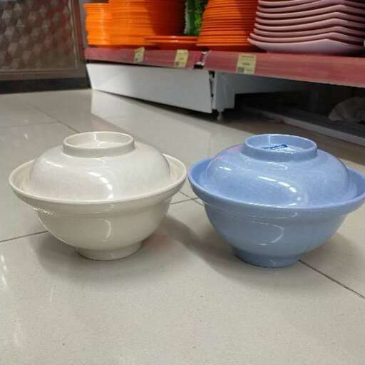 a couple of bowls and bowls sitting on a floor.