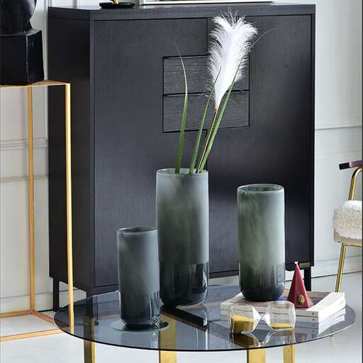 a black and gold table with two vases on it.
