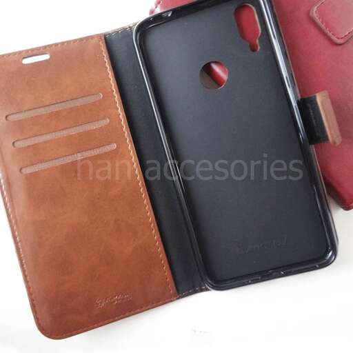 a brown leather wallet with a red strap.