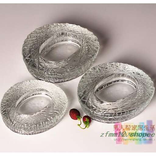 two silver plates with a strawberry on them.