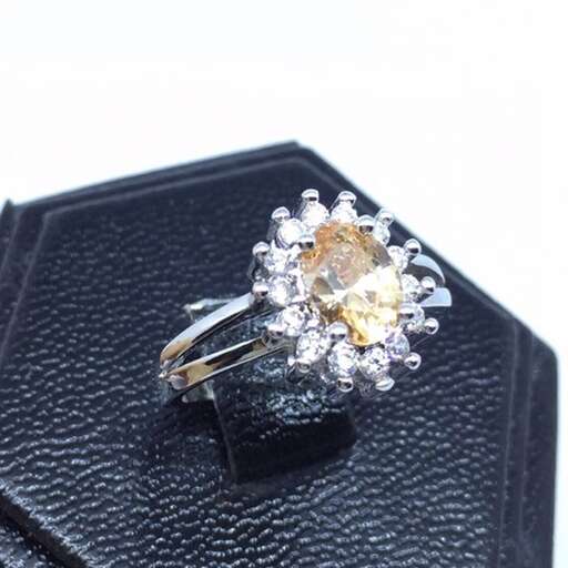 a yellow diamond ring with a carat stone.