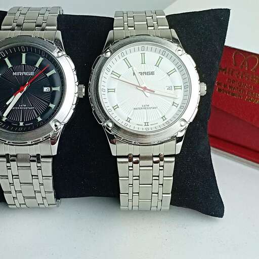 a pair of watches are on a table.