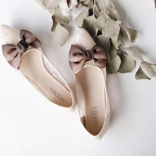 a pair of shoes with bow ties and leaves.