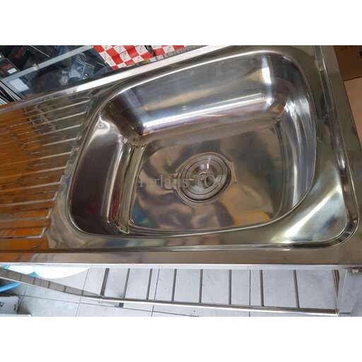 a stainless steel sink sitting on top of a counter.