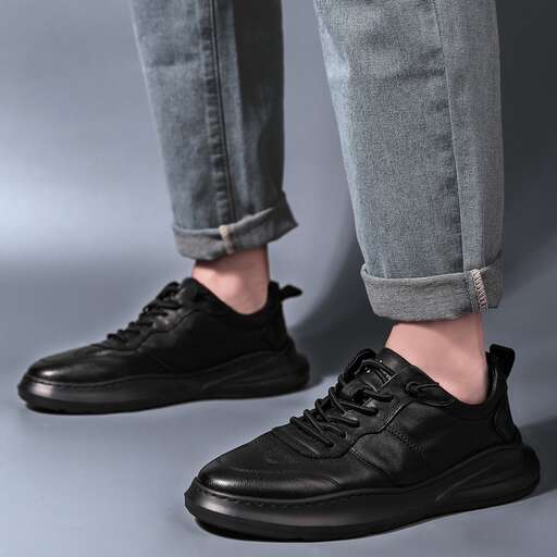 a pair of black leather shoes with a touch of laces