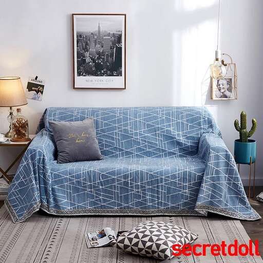 a blue and white bedroom with a bed and a picture of a cactus