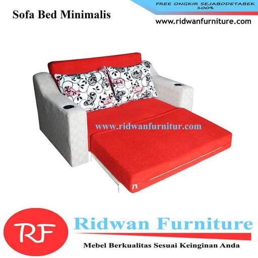 a bed with a red cushion and a white and black floral print bed.