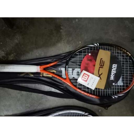 a tennis racket with a face on it.
