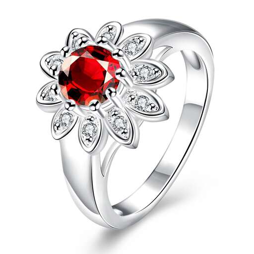 a ring with a red sapphire and diamonds