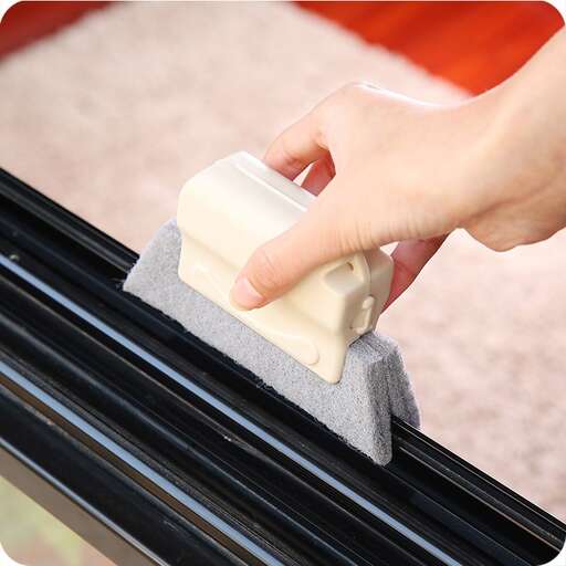 hand holding a sponge on a car window