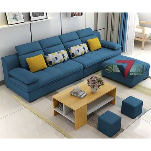 a blue couch sitting in a living room next to a coffee table.