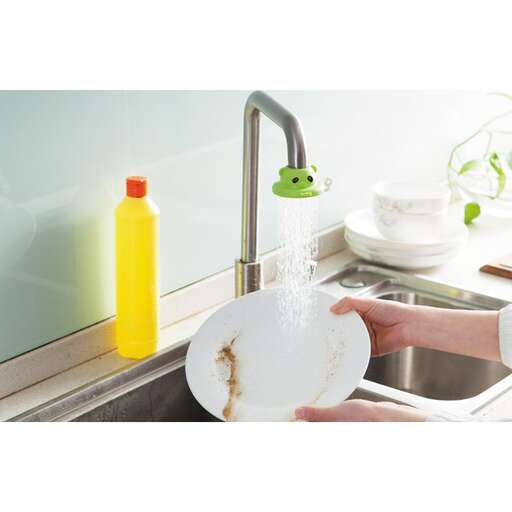 a person holding a plate over a sink