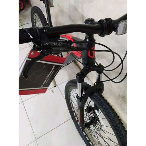 a bicycle with a box attached to it's front wheel.