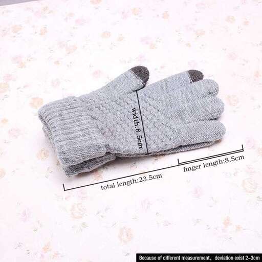 a pair of gloves on a bed with flowers.