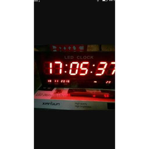 a digital clock with the time displayed on a wall.