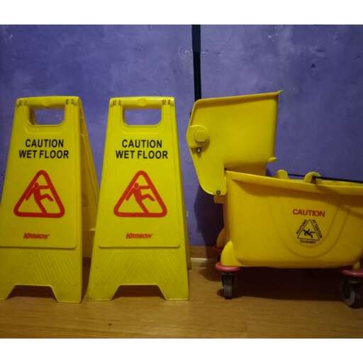 a couple of yellow caution signs next to a yellow caution sign.