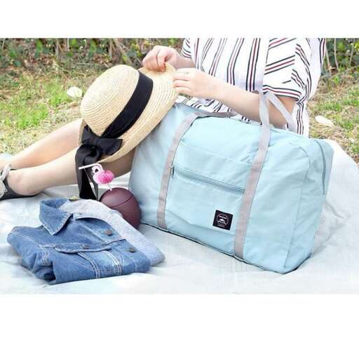 a woman sitting on a blanket with a hat on her head.