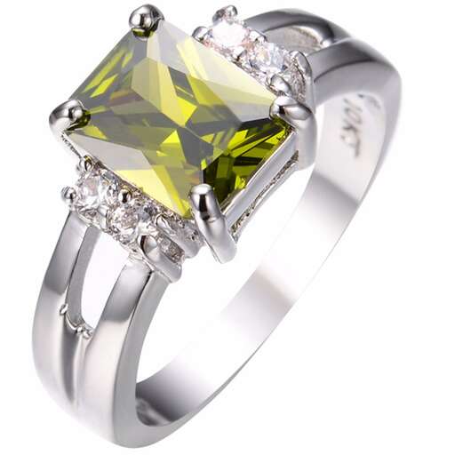 a diamond ring with a green diamond