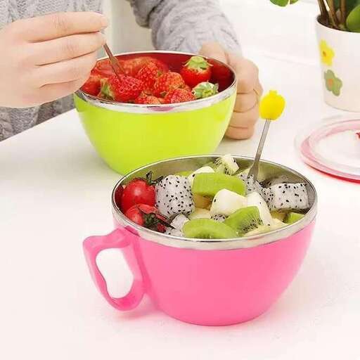 a woman is preparing a salad in a pink bowl.