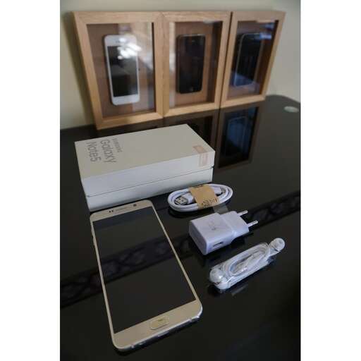 a table with a box, phone, and other items on it.