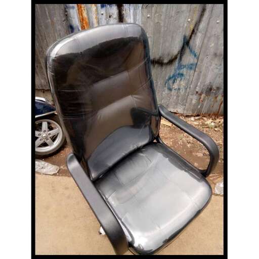 a chair that is sitting on a sidewalk.