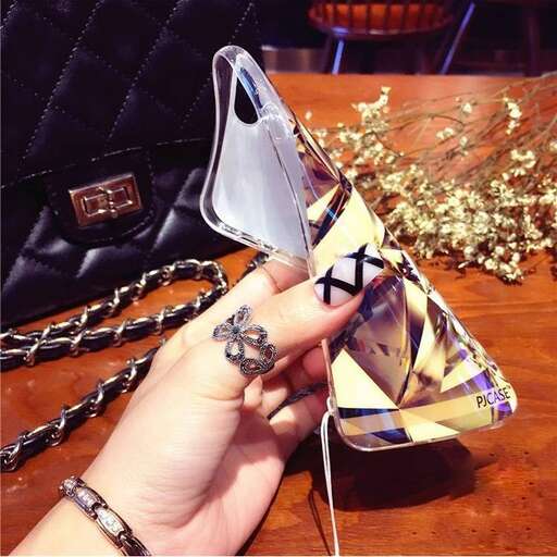 a hand holding a purse with a keychain