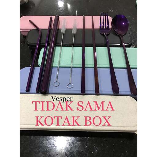 a box of forks and spoons on a table.