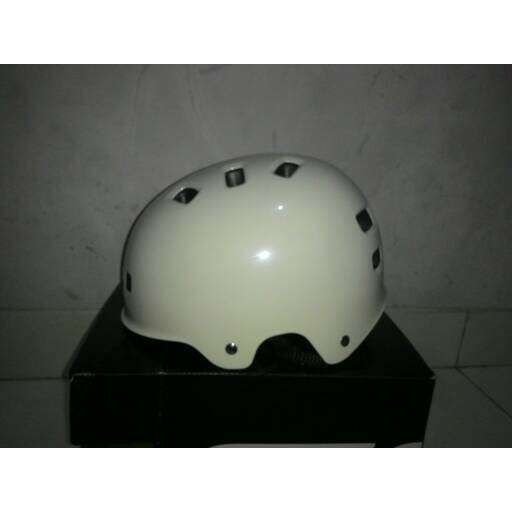 a white helmet with holes on it sitting on a box.