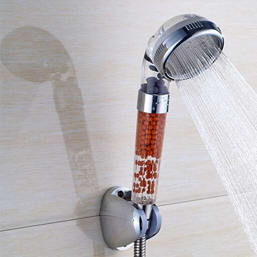 a shower head with a shadow on the wall