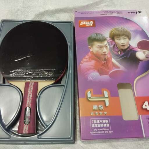 a pair of headphones sitting next to a box of scissors.