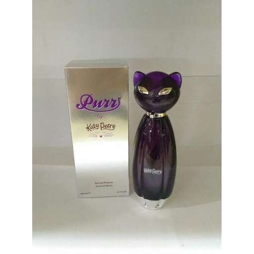 a cat shaped perfume bottle sitting on a white surface.
