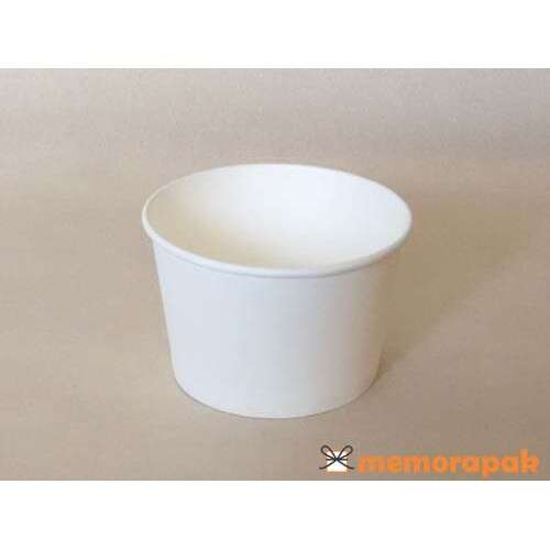 a white bowl with a lid on a white surface.