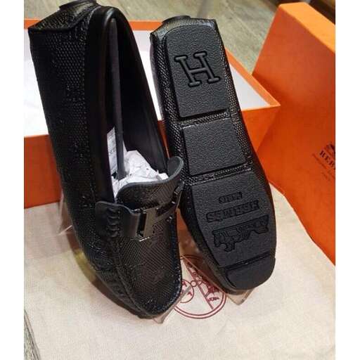 a pair of black shoes with a small pocket.