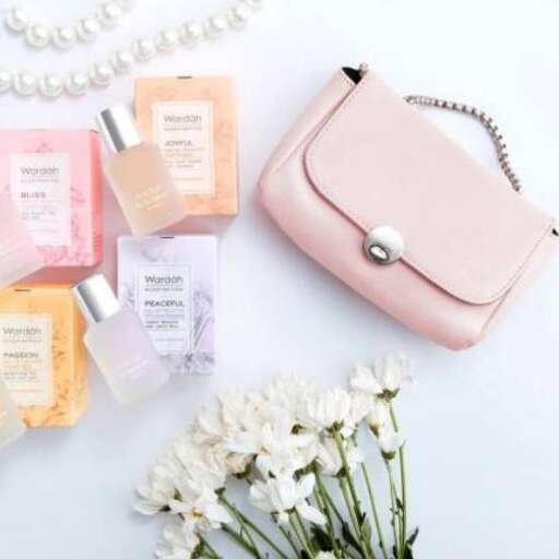 a pretty pink bag with a white flower in the middle.