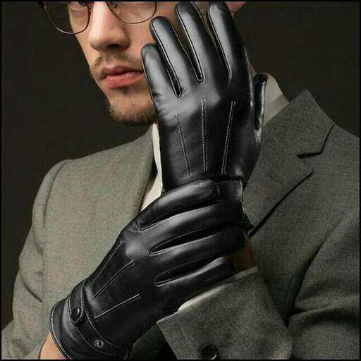 a man in a suit and tie holding a glove.