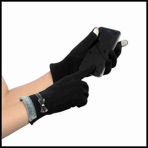 a person wearing gloves holding a cell phone.