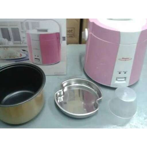 a pink and white appliance sitting on a counter.