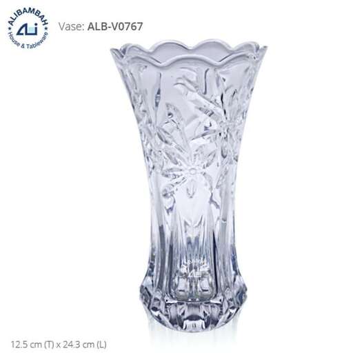 a tall glass vase with a design of a tree on top.