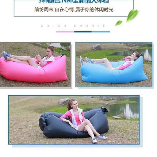 a girl sitting on a bean bag chair in a park.