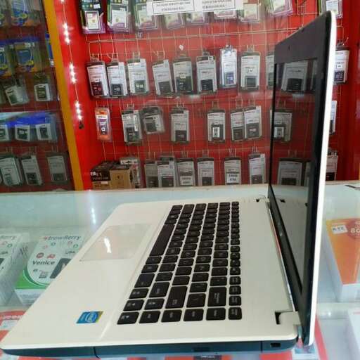 a laptop computer sitting on top of a display case.