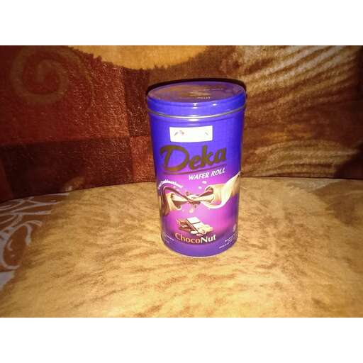 a cup of chocolate in a purple tin