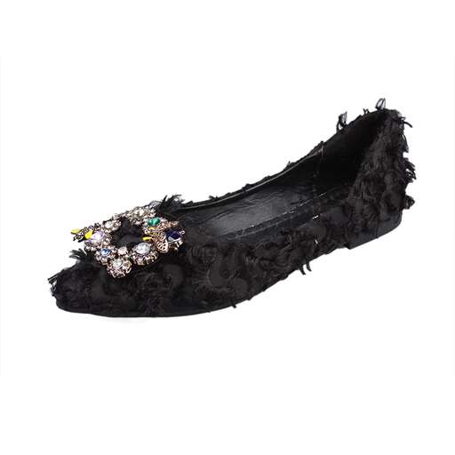 a pair of black shoes with diamonds