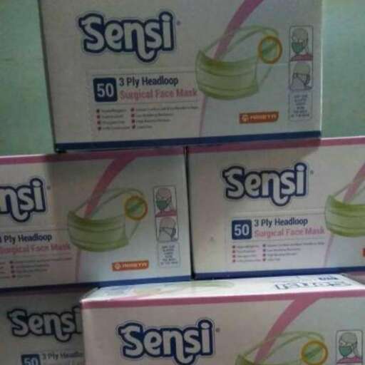 a stack of boxes with a toilet paper in the background.