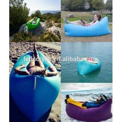 a person laying on a raft on a beach.